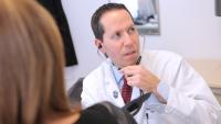 Cardiologist exams patient with heart condition